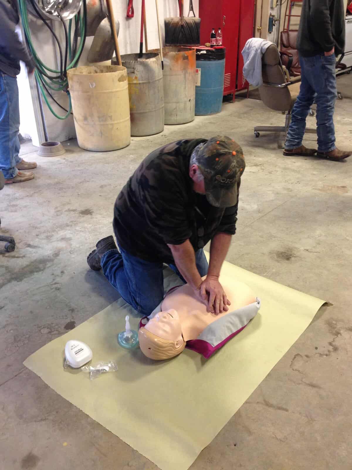CPR training class on medical dummy at West-Hodson workshop environment.