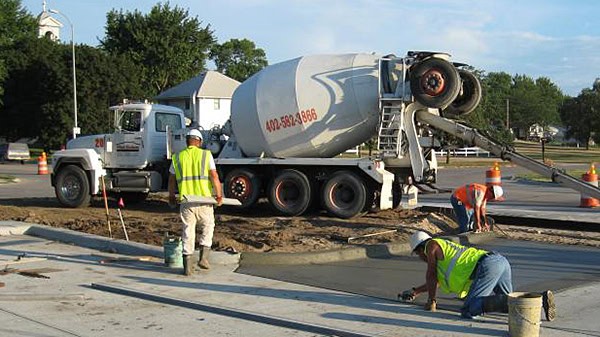 Concrete pouring and foundation work in progress at construction site.