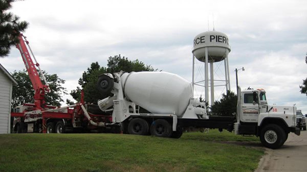 Concrete mixer truck with a pumping system at West-Hodson construction site.