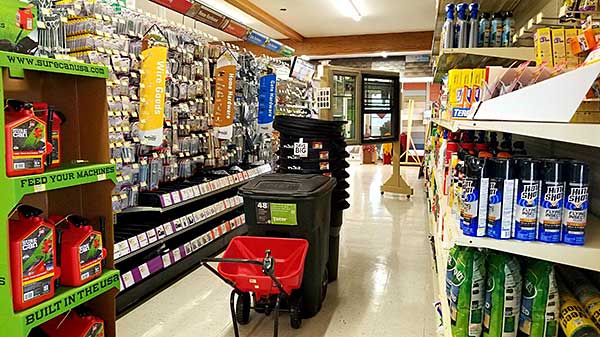 Aisle view of West-Hodson hardware store displaying tools, supplies, and cleaning products.